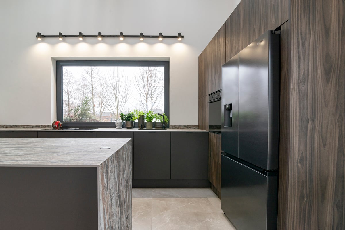 Kitchen overview with island and appliance tower